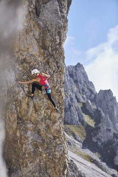 Austria, Innsbruck, Nordkette, woman climbing in rock wall