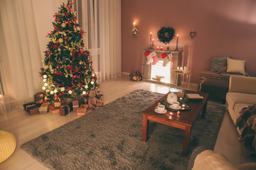 Stylish interior of living room with beautiful Christmas fir tree
