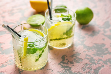 Glasses of fresh mojito on light table