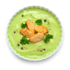 Bowl with tasty zucchini soup on white background