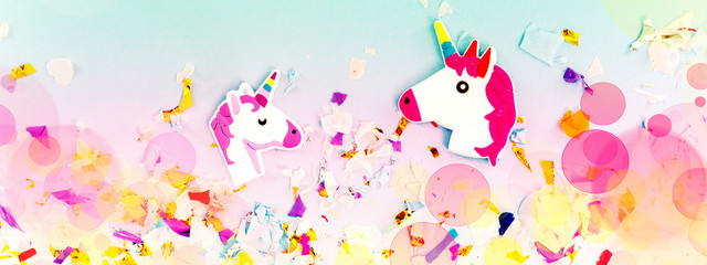 Fototapeta na wymiar A white unicorn with rainbow horn and confetti top view.