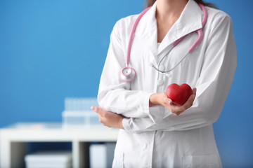 Cardiologist with red heart in clinic