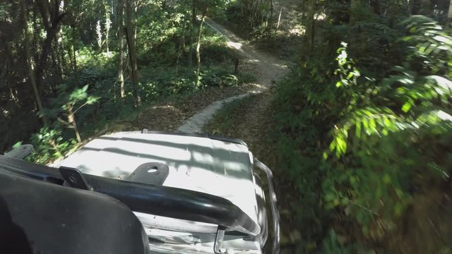 POV 4x4 driving jeep vehicle Wilderness safari mountain forest dirt road Chiangmai Thailand