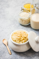 Healthy breakfast rice and millet porridge in a pot. Selective focus, space for text.