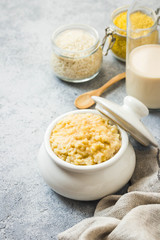 Healthy breakfast rice and millet porridge in a pot. Selective focus, space for text.