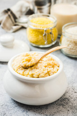Healthy breakfast rice and millet porridge in a pot. Selective focus, space for text.