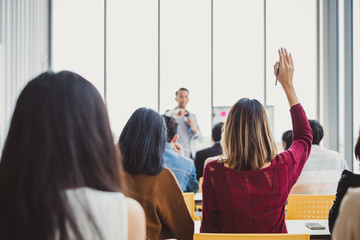Business woman raising hand for asking speaker for question and answer concept in meeting room for...