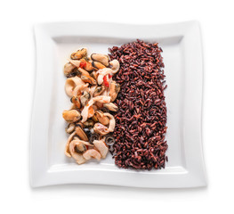 Tasty boiled wild rice with seafood on plate, isolated on white