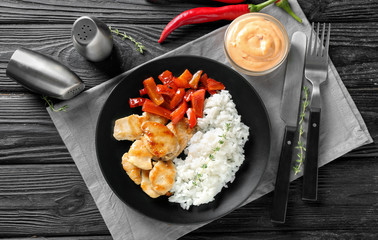 Tasty boiled rice with meat and pepper on plate