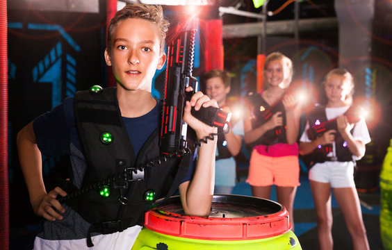 Boy with laser pistol in laser tag labyrinth