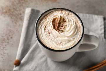 Cup of delicious cocoa on table, closeup