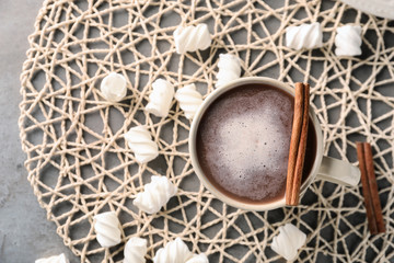 Fototapeta na wymiar Cup of delicious cocoa and marshmallows on napkin