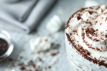 Cup of delicious cocoa with cream, closeup