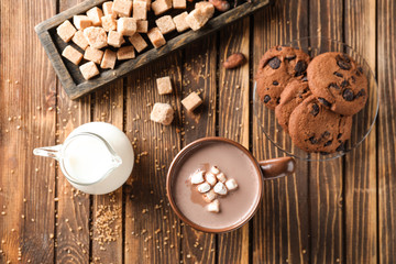 Composition with delicious cocoa on wooden table