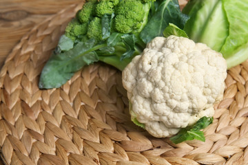 Different types of cabbage on wicker mat