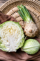 Ripe cabbage and celery on wicker plate