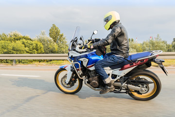 Motorcyclist riding fas his new mdern motorcycle