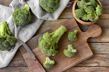 Composition with fresh green broccoli on wooden table