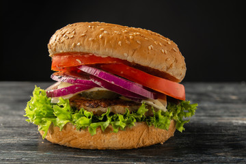 White and black hamburgers are served in different angles and with different fillings