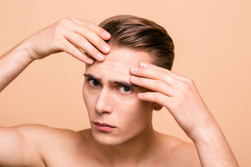 Fototapeta premium Portrait of upset, frustrated, naked brown-haired man looking fo