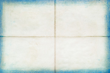 Blank old letter folded in four with blue edges, texture background