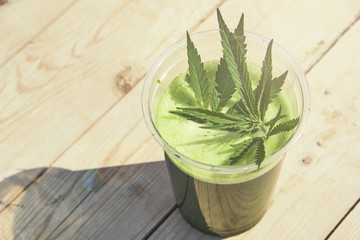 Healthy cannabis smoothie on wooden background. Natural supplement, detox and healthy living