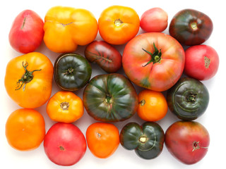 Composition of red, green and yellow tomatoes, top view. 