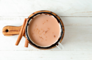 Cup of tasty cocoa on white table