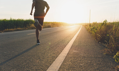 The man with runner on the street be running for exercise.