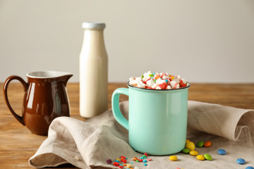 Composition with tasty cocoa on wooden table
