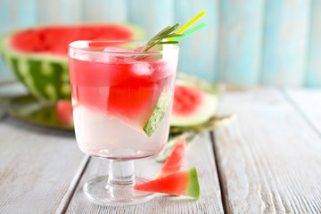 Fresh summer cocktail in glass on light wooden table