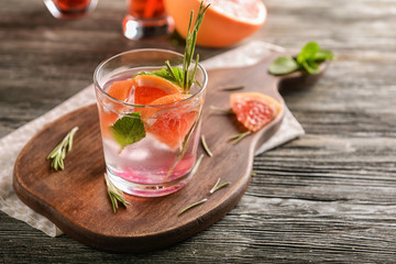 Fresh summer cocktail in glass on wooden board