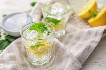 Glasses of fresh lemonade on table