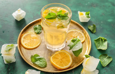 Glass of fresh lemonade on metal tray
