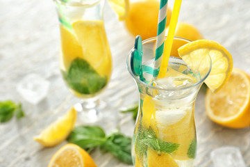 Glass of fresh lemonade on table