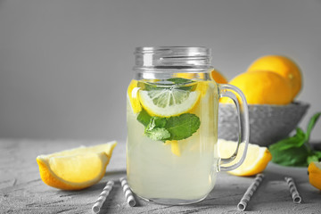 Mason jar of fresh lemonade on table