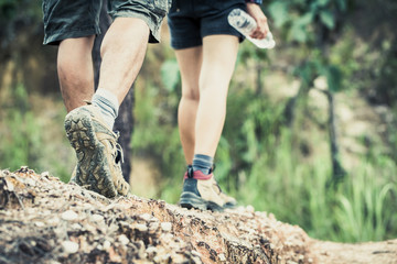 Cropped image of a backpacking couple walking along their hiking trail