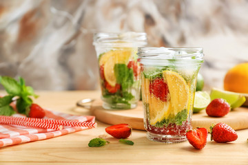 Jar of fresh strawberry lemonade on wooden table