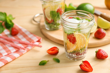 Jar of fresh strawberry lemonade on wooden table
