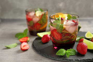 Glass of fresh strawberry lemonade on slate plate