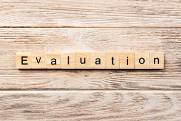 evaluation word written on wood block. evaluation text on table, concept