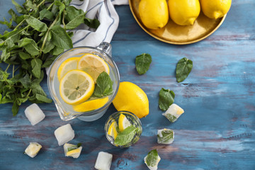 Glassware of fresh lemonade on wooden table
