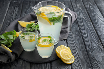 Glassware of fresh lemonade on wooden table