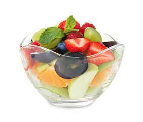 Delicious fruit salad in glass bowl on white background
