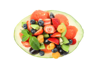 Delicious fruit salad in melon bowl on white background