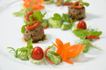 creative food design on white plate with spices and sauce