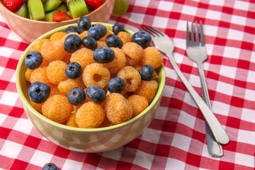 Delicious fruit salad in bowl on table