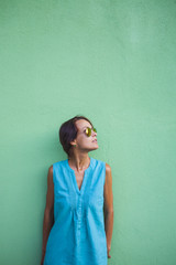 Fototapeta premium Girl on the background of a green wall.