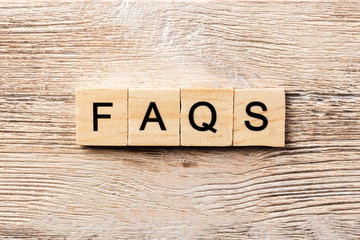 faqs word written on wood block. faqs text on table, concept