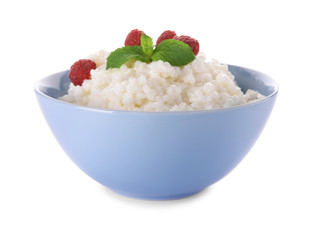 Delicious rice pudding with raspberry in bowl on white background